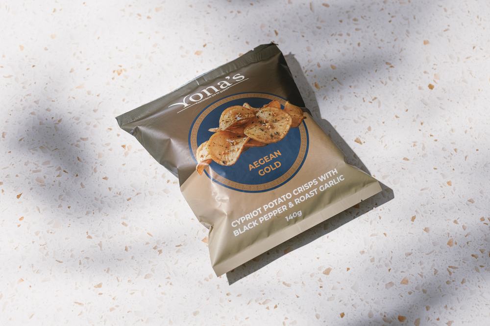 Aegean Gold 140g bag lying at an angle on terrazzo